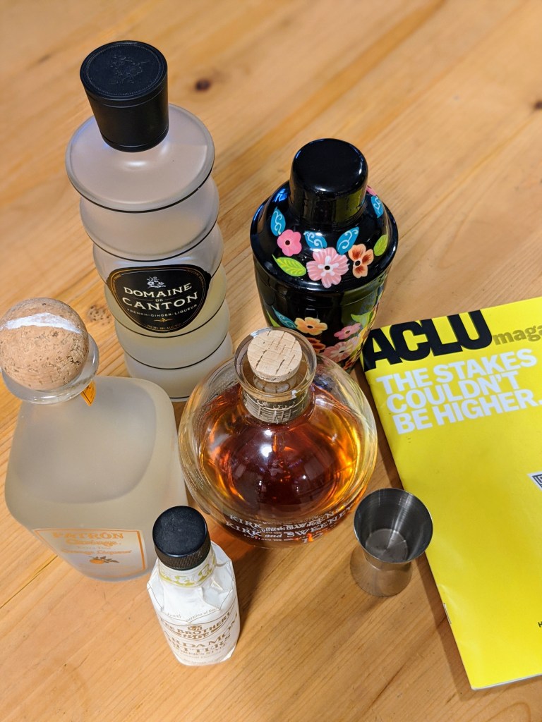 A vibrant cocktail shaker next to all the ingredients in this recipe. And an ACLU magazine with the text "the stakes couldn't be higher"